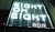 Neon sign displaying the text "EIGHT OH EIGHT 303" in bright colors, illuminated against a dark background.